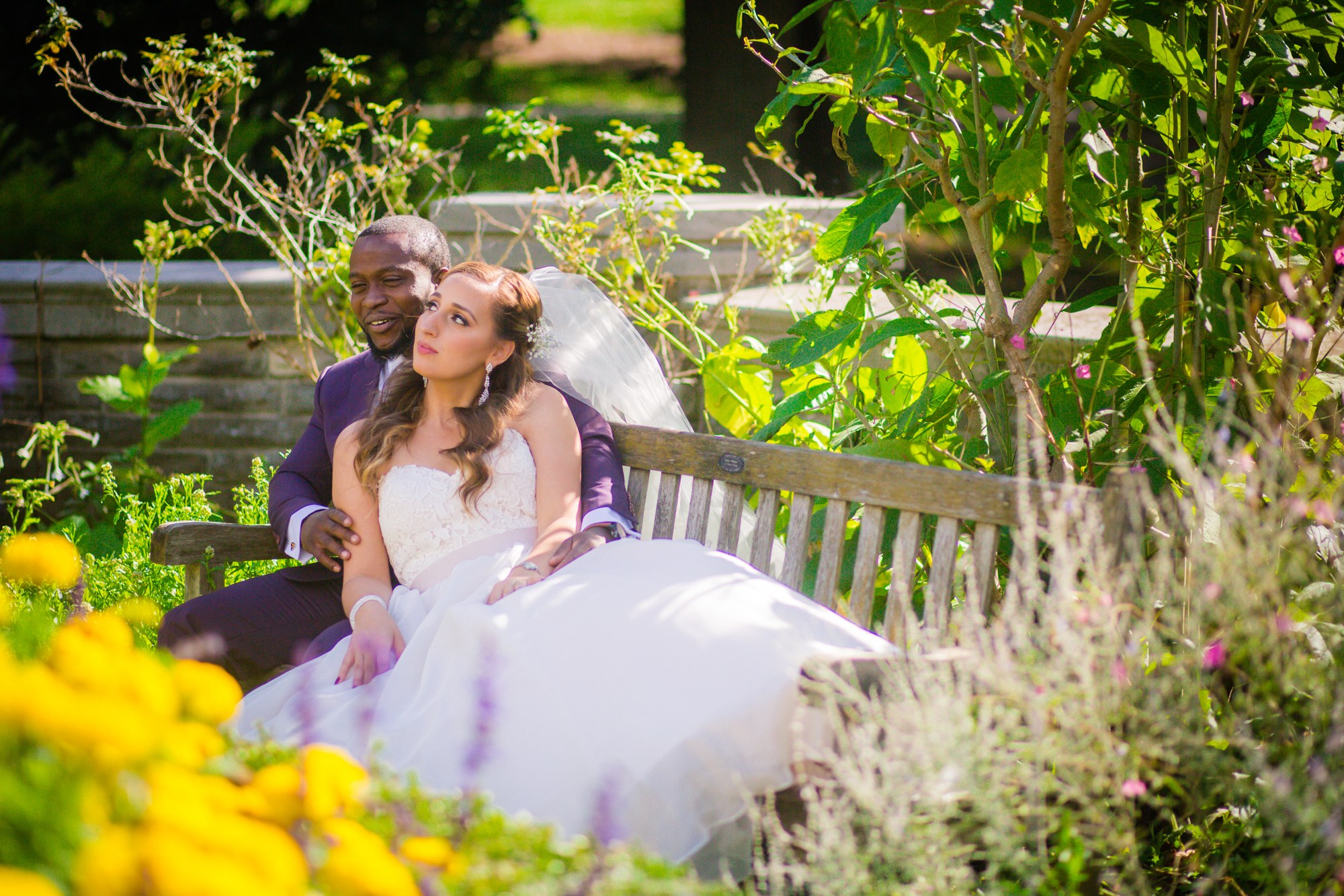 Couple seated on a garden bench in warm light
