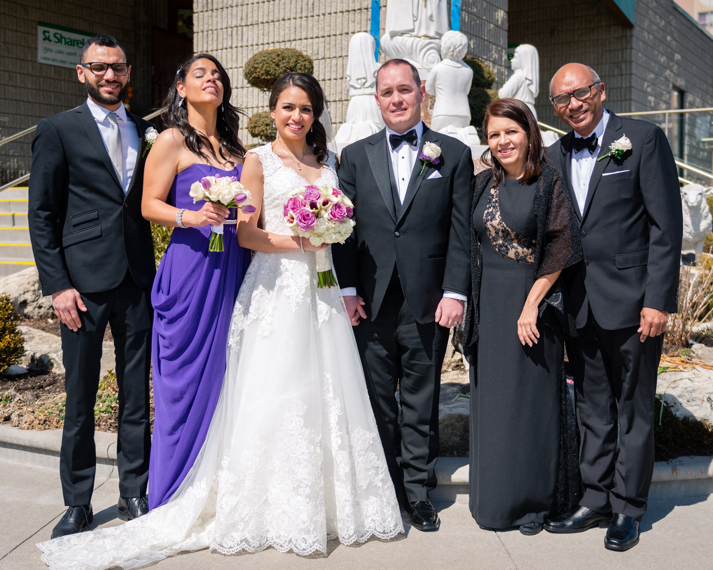 Family wedding portrait outside a stone building