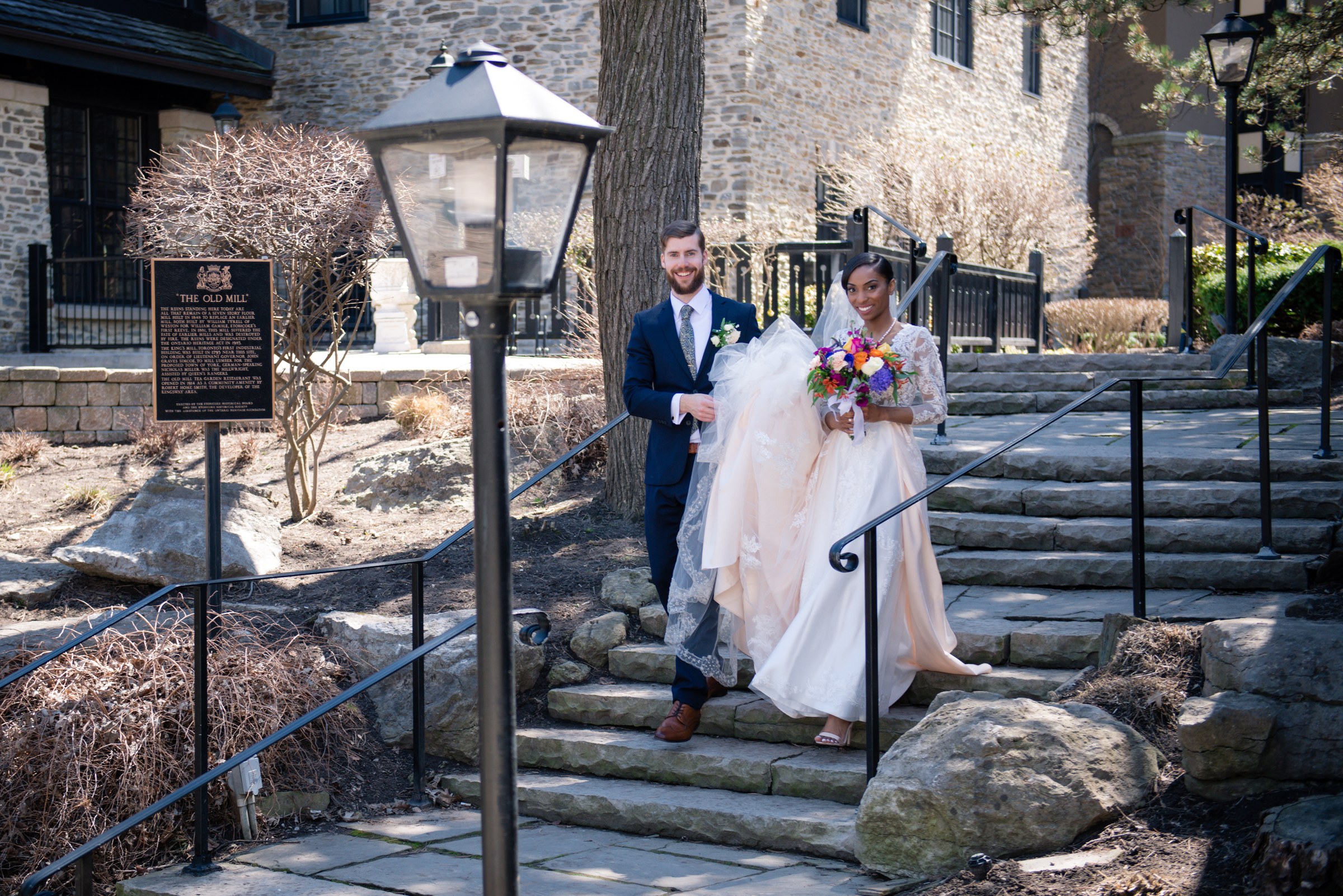 Couple on stone steps beside a historic building