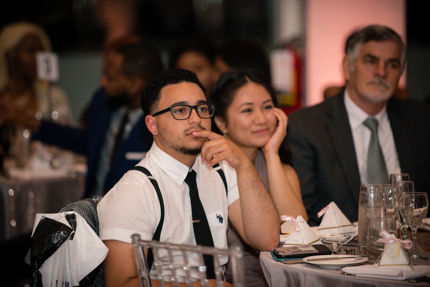 Guests listening together during the wedding reception