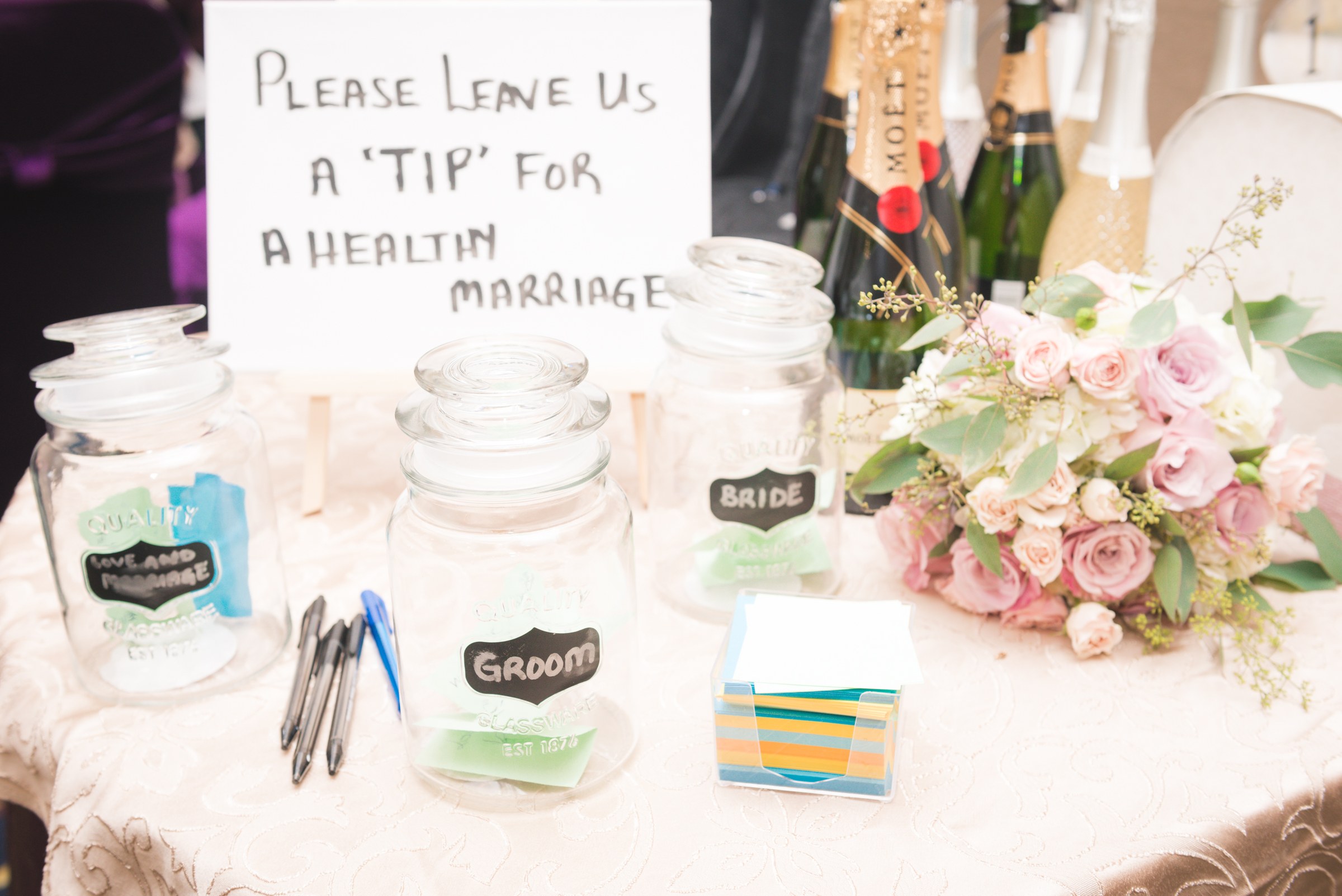 Wedding advice cards beside floral table decorations