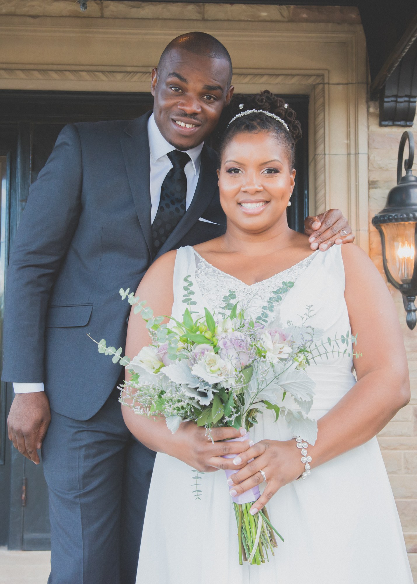 Newlyweds smiling together at the doorway
