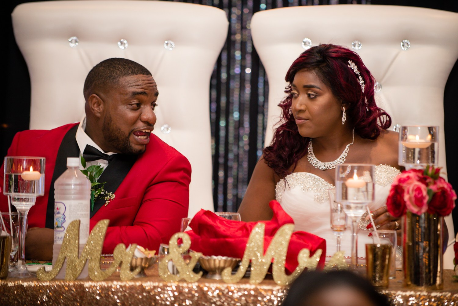 Newlyweds sharing a moment at their reception table