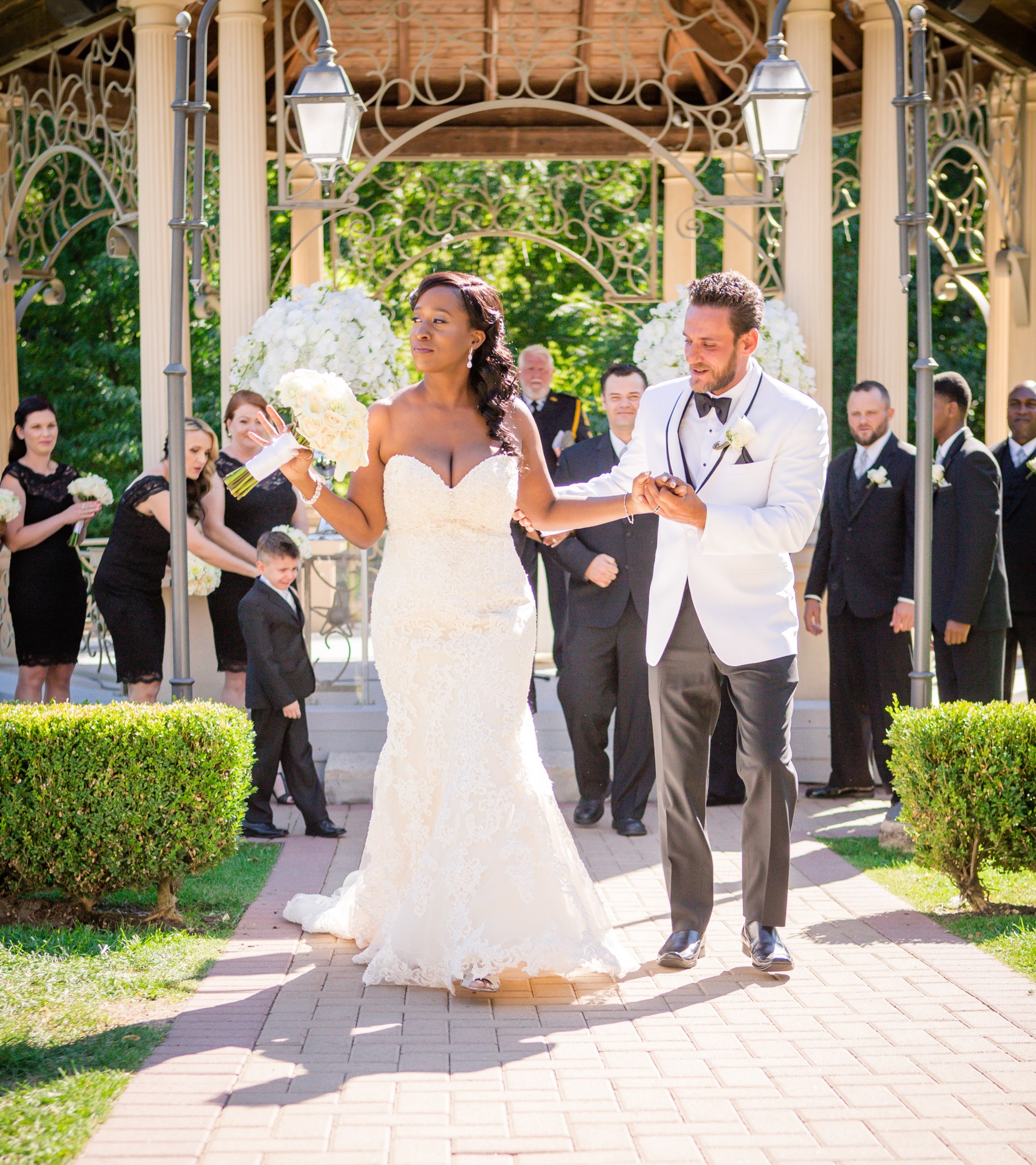 Newlyweds walking from their outdoor ceremony